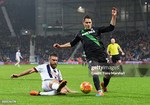 Rickie Lambert of West Bromwich Albion and Philipp Wollscheid of Stoke City compete for the ball during the Barclays Premier League match between...