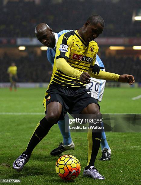 Odion Ighalo of Watford holds off Eliaquim Mangala of Manchester City during the Barclays Premier League match between Watford and Manchester City at...