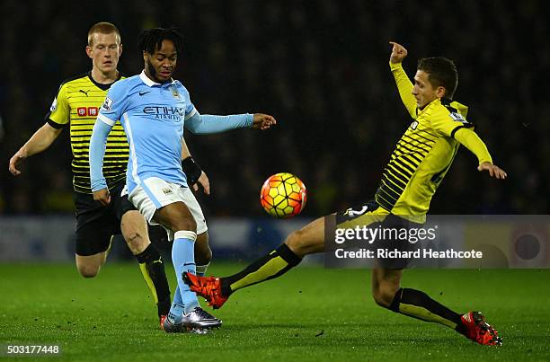 Raheem Sterling of Manchester City takes a shot at goal under pressure from Almen Abdi of Watford during the Barclays Premier League match between...