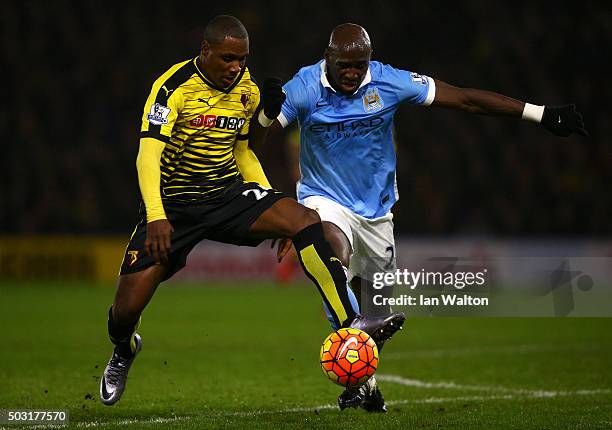 Odion Ighalo of Watford battles for the ball with Eliaquim Mangala of Manchester City during the Barclays Premier League match between Watford and...