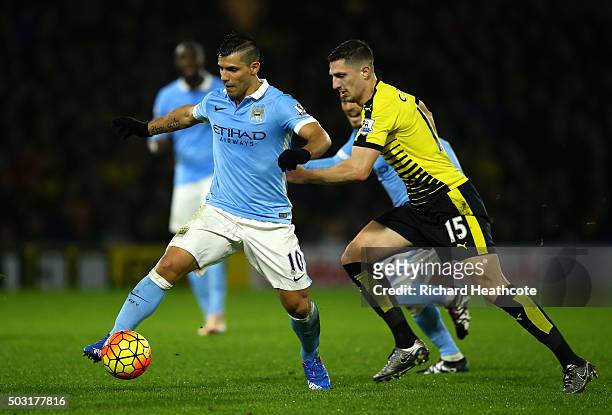 Sergio Aguero of Manchester City holds off Craig Cathcart of Watford during the Barclays Premier League match between Watford and Manchester City at...