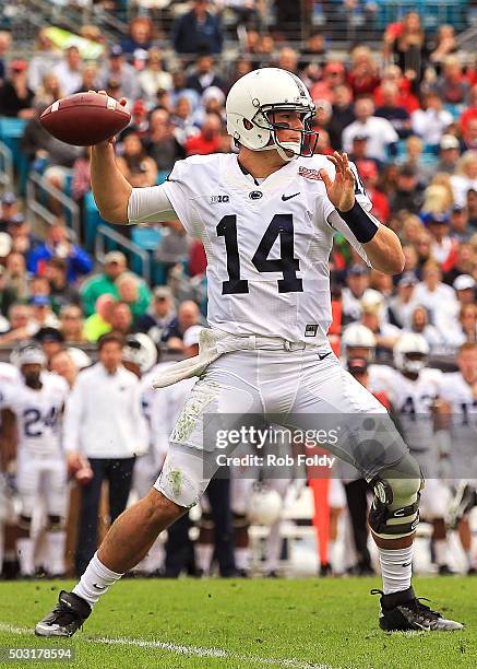 Christian Hackenberg of the Penn State Nittany Lions drops back to throw during the first half of the TaxSlayer Bowl game against the Georgia...