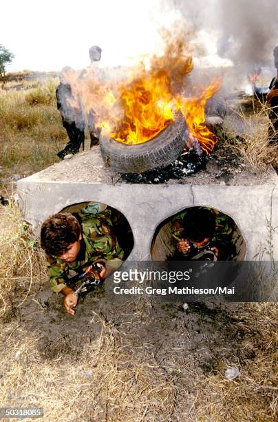 Kurdish special operations peshmerga training on an obstacle course which forces them through metal tunnels heated up with fires on top. The Kurds...