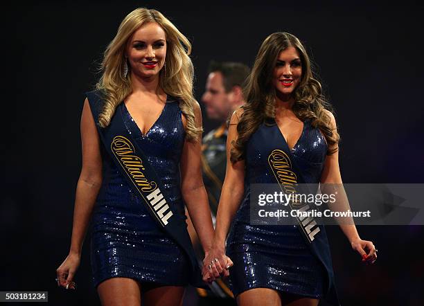 The walk on girls exit the stage during the semi-final match between Adrian Lewis of England and Raymond van Barneveld of Holland during the 2016...