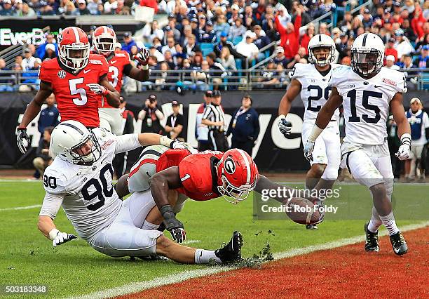 Sony Michel of the Georgia Bulldogs reaches past Garrett Sickels of the Penn State Nittany Lions to score a touchdown during the second half of the...