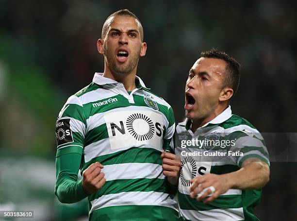 Sporting CP's forward Islam Slimani celebrates with teammate Jefferson after scoring a goal during the Primeira Liga match between Sporting CP and FC...