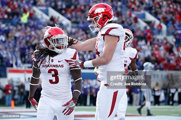 Alex Collins of the Arkansas Razorbacks celebrates after rushing for a 13-yard touchdown against the Kansas State Wildcats in the second quarter of...