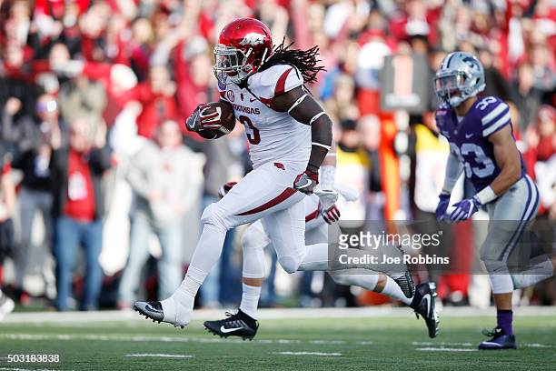 Alex Collins of the Arkansas Razorbacks breaks free for a 22-yard touchdown run against the Kansas State Wildcats in the first quarter of the...