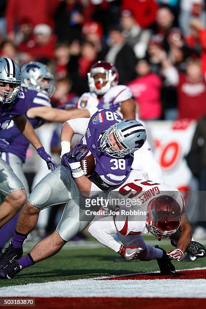 Winston Dimel of the Kansas State Wildcats pushes into the end zone for a 10-yard touchdown against Rohan Gaines of the Arkansas Razorbacks in the...