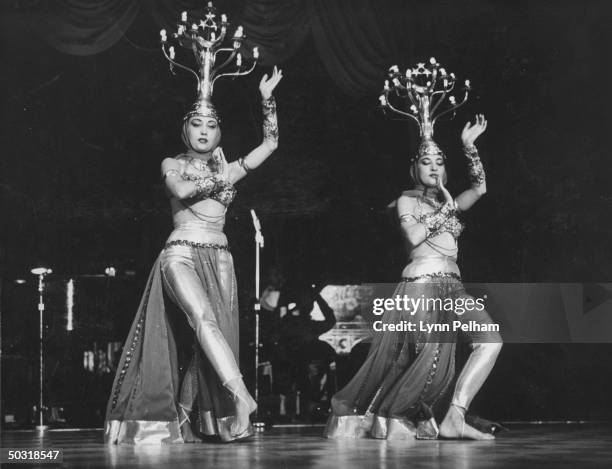 Egyptian twins belly dancing at the Eden Roc night club.