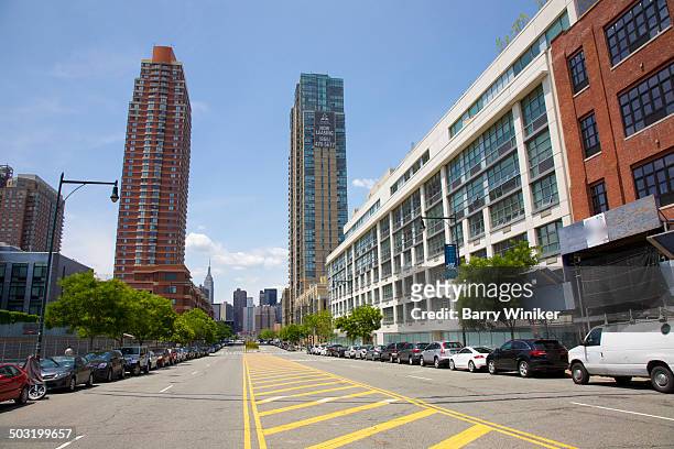 wide queens street leading to new towers and city - queens new york stock pictures, royalty-free photos & images