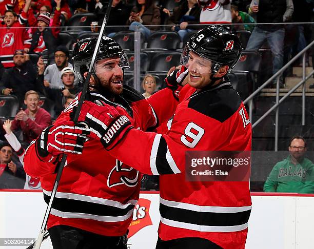 Kyle Palmieri of the New Jersey Devils is congratulated by teammate Jiri Tlusty after Palmieri scored a goal in the second period against the Dallas...