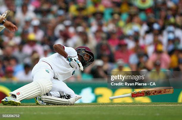 Kraigg Brathwaite of West Indies slips over before Marlon Samuels of West Indies is run out during day one of the third Test match between Australia...