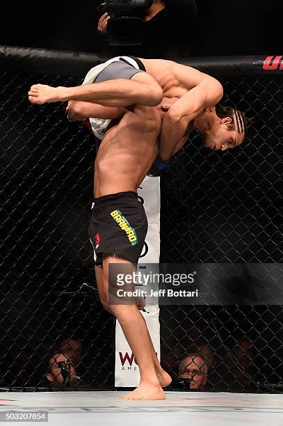 Diego Brandao of Brazil lifts up Brian Ortega in their featherweight bout during the UFC 195 event inside MGM Grand Garden Arena on January 2, 2016...