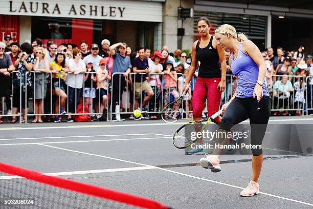 Caroline Wozniacki takes part in an exhibition tennis match with New Zealand netball player Maria Tutaia on January 3, 2016 in Auckland, New Zealand....