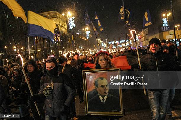 Hundreds of activists and supporters of Ukrainian nationalists march with torches and flags in downtown Kiev during a rally confined to the 107th...