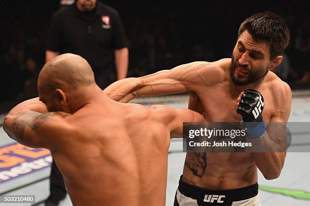 Carlos Condit punches Robbie Lawler in their UFC welterweight championship bout during the UFC 195 event inside MGM Grand Garden Arena on January 2,...