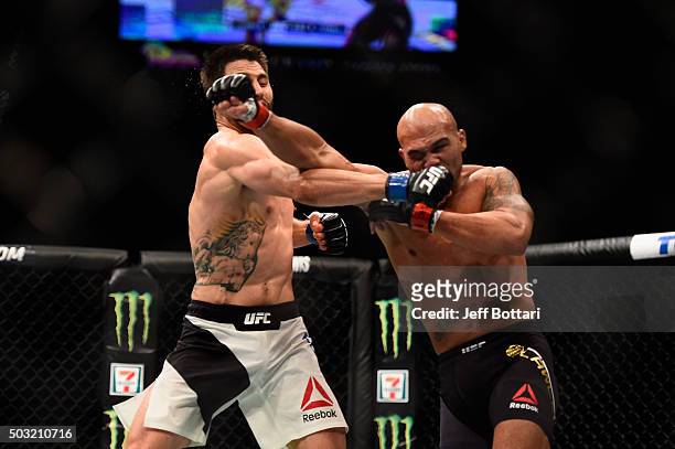 Carlos Condit punches Robbie Lawler in their UFC welterweight championship bout during the UFC 195 event inside MGM Grand Garden Arena on January 2,...