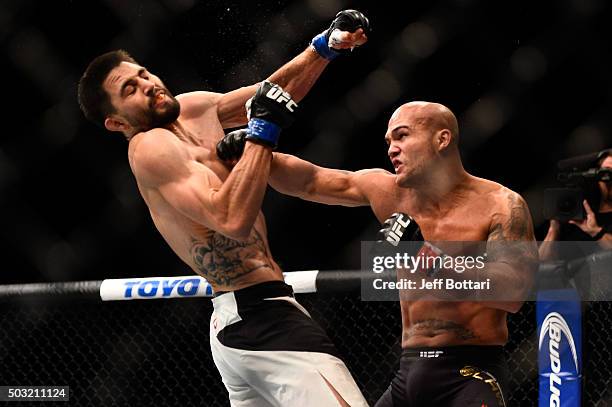 Robbie Lawler punches Carlos Condit in their UFC welterweight championship bout during the UFC 195 event inside MGM Grand Garden Arena on January 2,...