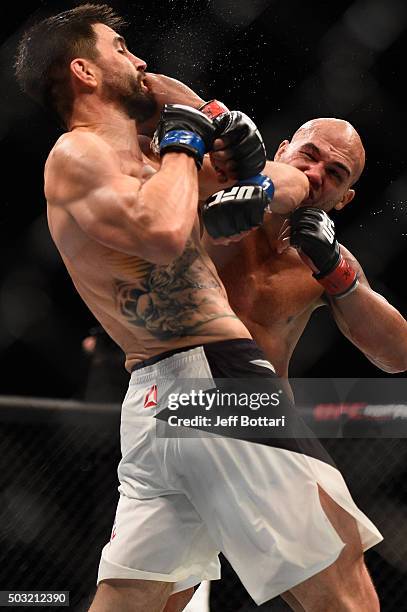 Robbie Lawler punches Carlos Condit in their UFC welterweight championship bout during the UFC 195 event inside MGM Grand Garden Arena on January 2,...