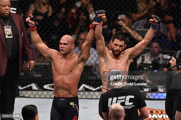 Robbie Lawler and Carlos Condit react after their UFC welterweight title bout during the UFC 195 event inside MGM Grand Garden Arena on January 2,...