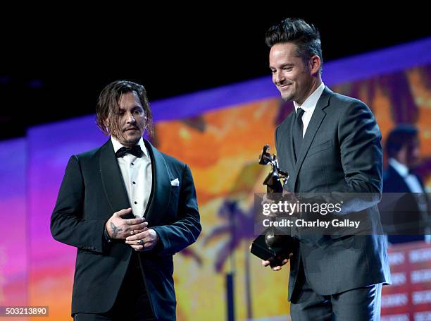 Actor Johnny Depp accepts the Desert Palm Achievement Award with Scott Cooper onstage at the 27th Annual Palm Springs International Film Festival...