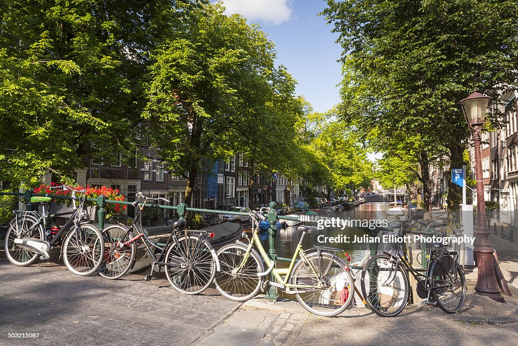 Bicycles line a canal bridge in Amsterdam