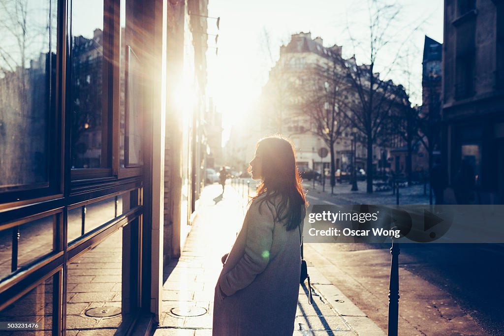 Asian woman walking on street in dawn