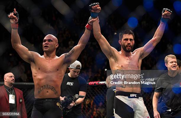 Robbie Lawler and Carlos Condit raise each others hands after their welterweight championship fight during the UFC 195 event inside MGM Grand Garden...