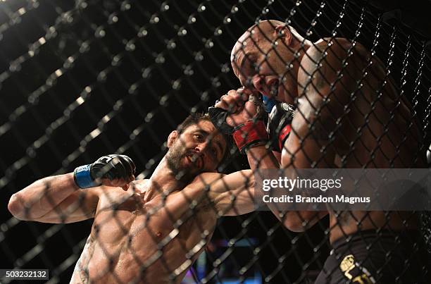 Carlos Condit punches Robbie Lawler in their welterweight championship fight during the UFC 195 event inside MGM Grand Garden Arena on January 2,...