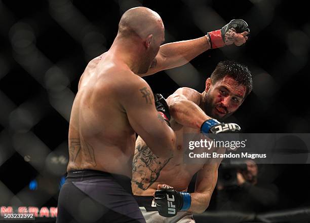 Carlos Condit punches Robbie Lawler in their welterweight championship fight during the UFC 195 event inside MGM Grand Garden Arena on January 2,...