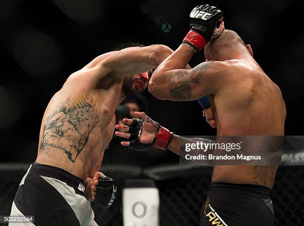 Carlos Condit punches Robbie Lawler in their welterweight championship fight during the UFC 195 event inside MGM Grand Garden Arena on January 2,...