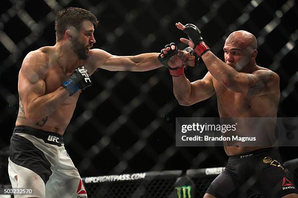 Carlos Condit punches Robbie Lawler in their welterweight championship fight during the UFC 195 event inside MGM Grand Garden Arena on January 2,...