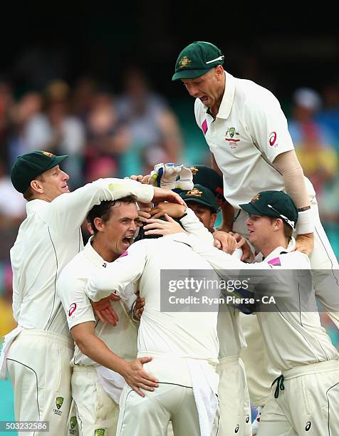 Steve O'Keefe and James Pattinson of Australia celebrate after Joe Burns of Australia caught Jason Holder of West Indies during day one of the third...