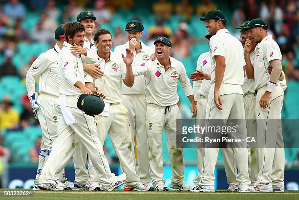 Steve O'Keefe and Joe Burns of Australia celebrate after combining to dismiss Jason Holder of West Indies during day one of the third Test match...