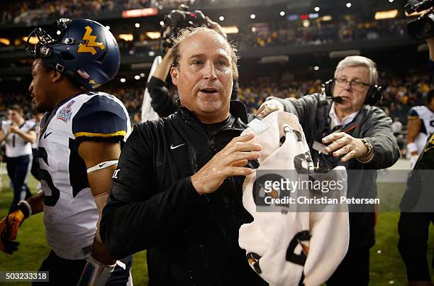 Head coach Dana Holgorsen of the West Virginia Mountaineers reacts after winning the Motel 6 Cactus Bowl against the Sun Devils at Chase Field on...