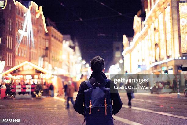 young man walking on a street in christmas - london market stock pictures, royalty-free photos & images