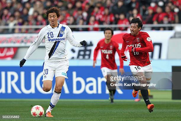 Shun Nagasawa of Gamba Osaka and Takuya Aoki of Urawa Red Diamonds compete for the ball during the 95th Emperor's Cup final between Urawa Red...