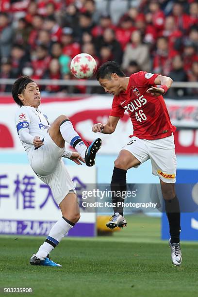 Yasuhito Endo of Gamba Osaka and Ryota Moriwaki of Urawa Red Diamonds compete for the ball during the 95th Emperor's Cup final between Urawa Red...