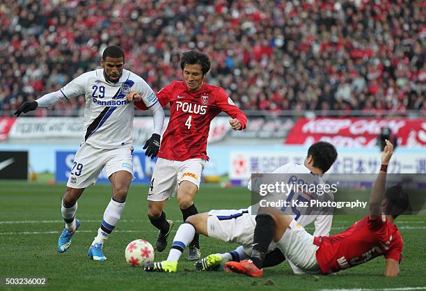 Patric of Gamba Osaka and Daisuke Nasu of Urawa Red Diamonds compete for the ball during the 95th Emperor's Cup final between Urawa Red Diamonds and...