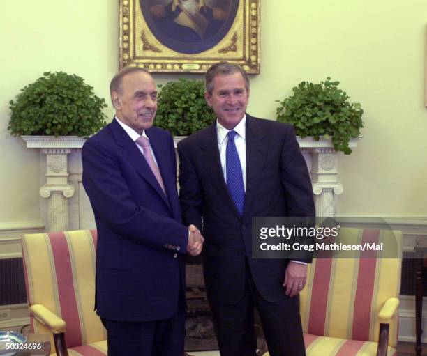 President George W. Bush meeting with Azerbaijan President Geidar Aliev during a working visit in the Oval Office of the White House.