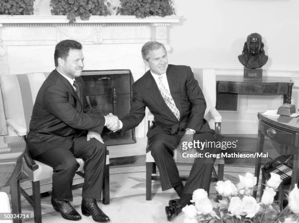 President George W. Bush meeting in the Oval Office of the White House w. King Abdullah II of Jordan.