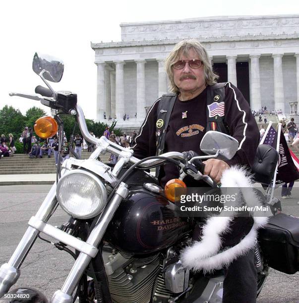 Singer Paul Revere of rock group Paul Revere and the Raiders on his Harley motorcycle in front of the Lincoln Monument, where he performed in a...