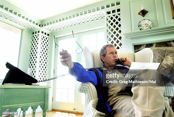 President George W. Bush during a phone call w. Russian President Vladimir Putin at the Bush family's East Coast vacation home.