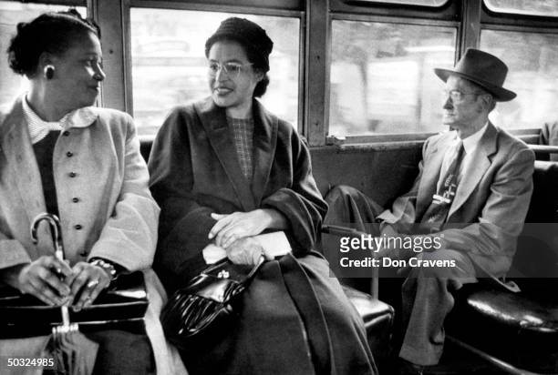 American civil rights activist, Rosa Parks , riding on a newly integrated bus following a Supreme Court ruling ending the successful 381 day...