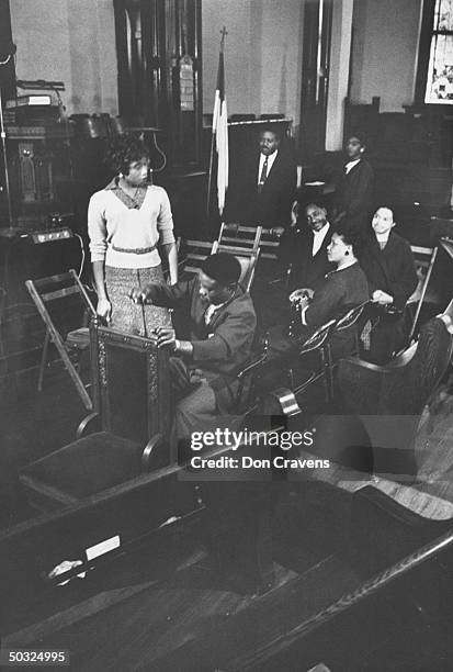 African Americans taking part in excercise in church to demonstrate how to show goodwill to whites on newly integrated buses following Supreme Court...