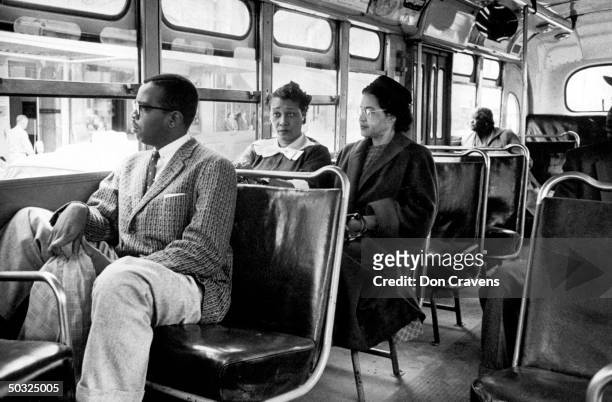 Rosa Parks riding on newly integrated bus following Supreme Court ruling ending successful 381 day boycott of segragated buses. Boycott began when...