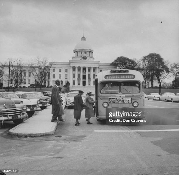African Americans boarding a newly integrated bus through the once-forbidden front door, following Supreme Court ruling ending successful 381 day...