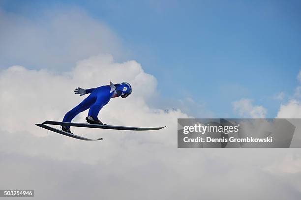 Michael Hayboeck of Austria soars through the air during his trial jump on Day 2 of the Innsbruck 64th Four Hills Tournament ski jumping event on...