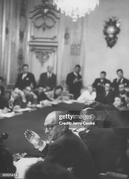 Guy Mollet executing a hand gesture at the conference microphone during the Suez Crisis.